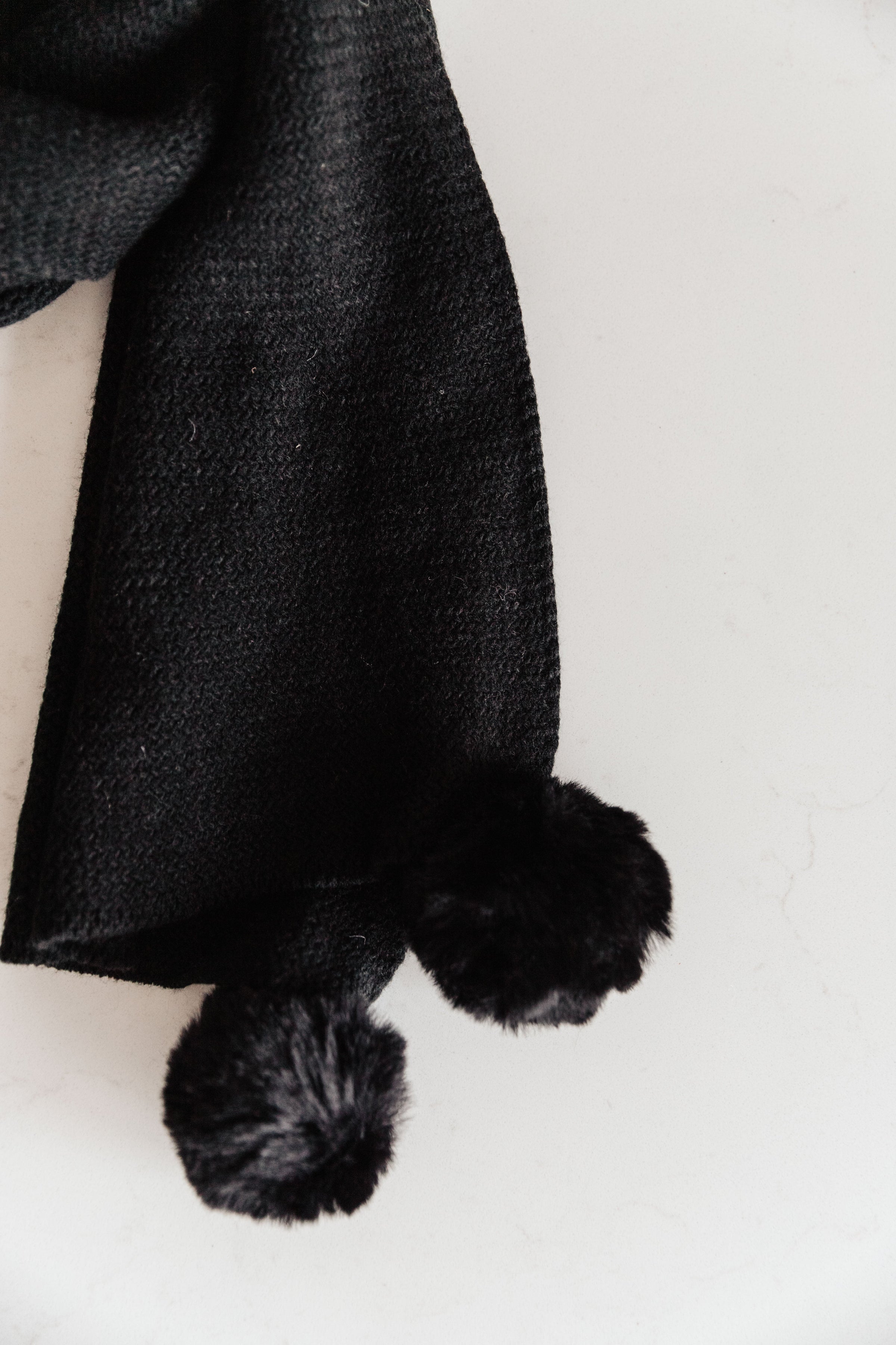 Knitted Fuzzy Pom Pom Scarf In Black